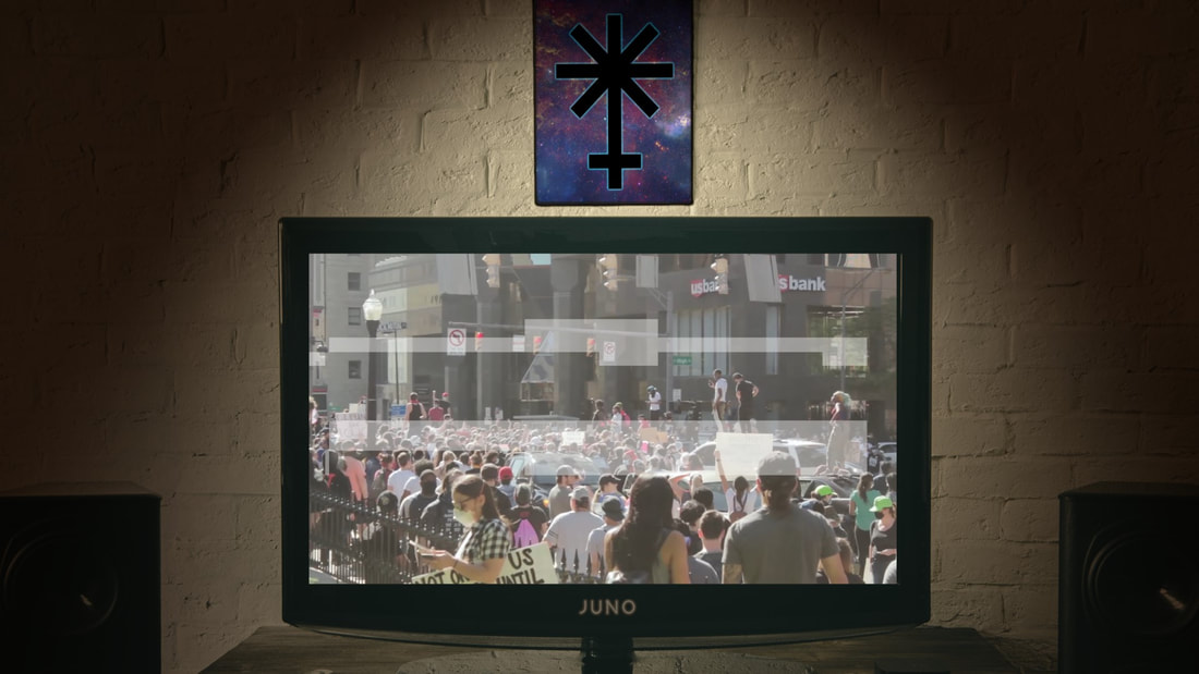 TV Set with protest imagery on it and J U N O icon on the wall